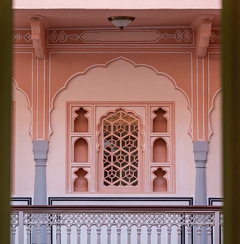 Pink haveli architecture with scalloped arches and jali screens at Padmaa Jaipur